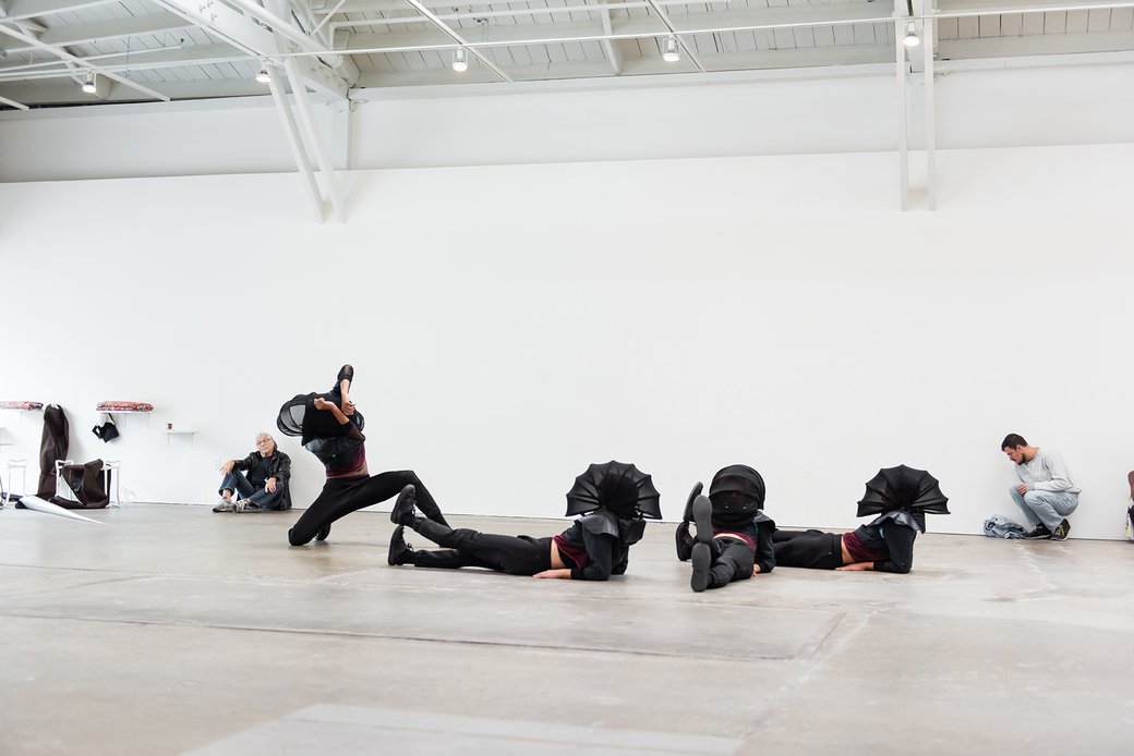 Four dancers at CCA's Wattis Institute performing Adam Linder Full Service Leah Katz, Justin F. Kennedy, Noha Ramadan, and Stephen Thompson.