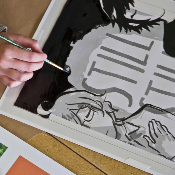 Close up of Illustration student painting a graphic poster.