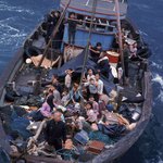 South Vietnamese refugees approach a U.S. warship in the South China Sea in 1975 to seek refuge from invaders from the north.