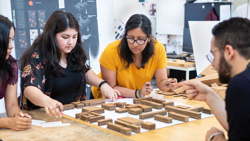 B'Arch students working together on a cardboard model