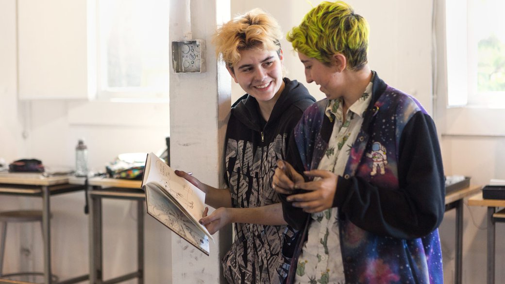 two pre-college students sharing art during the summer