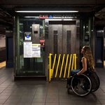 Girl in wheelchair in front of closed subway elevator.