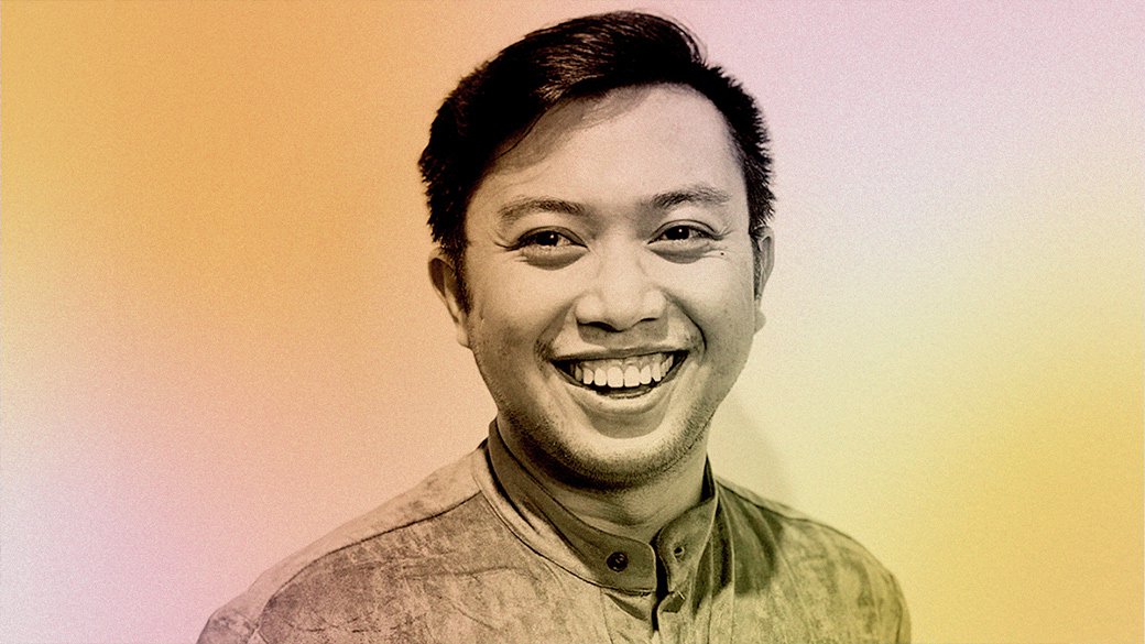 A pink and yellow filtered photo of Paul Mendoza.