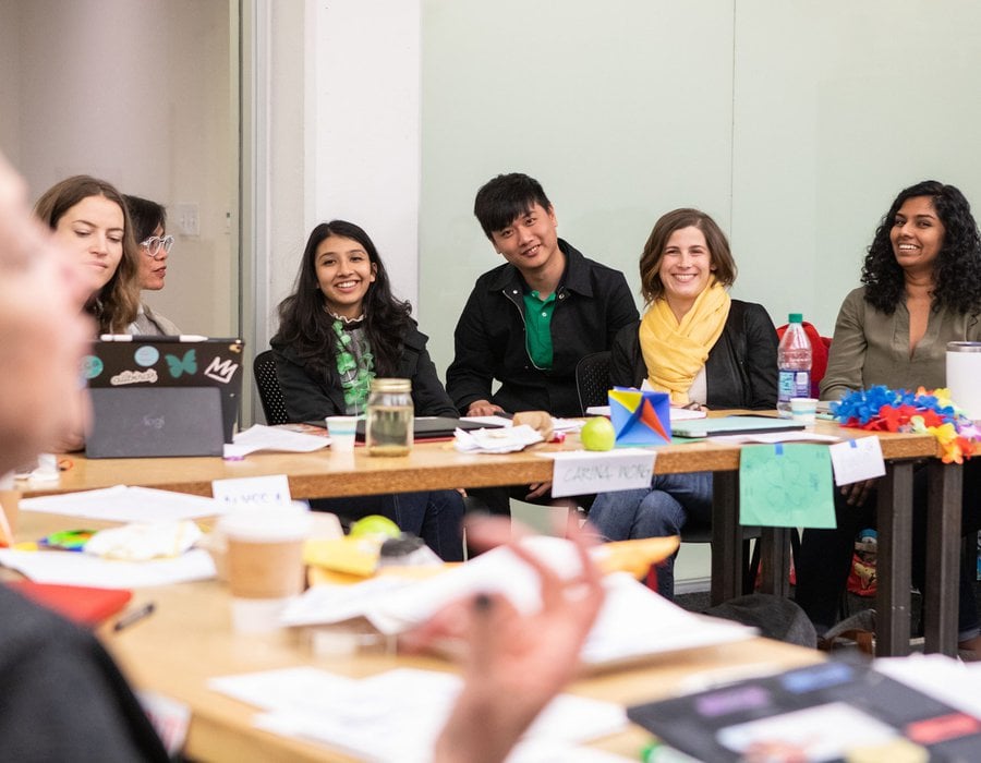 DMBA residency students laughing during a classroom game.