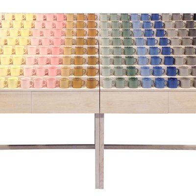 Colorful display of ceramic mugs by Atelier Dion.