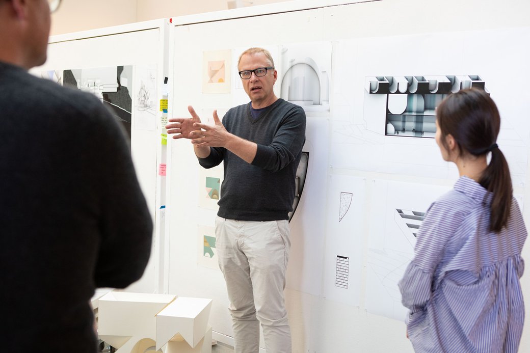 Keith Krumwiede speaking to students during M'Arch critiques.