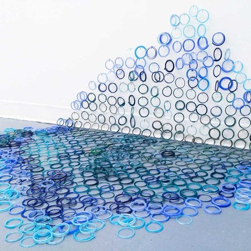 Blue carpet made of glass rings by Maggie Kelly, BFA student at CCA.