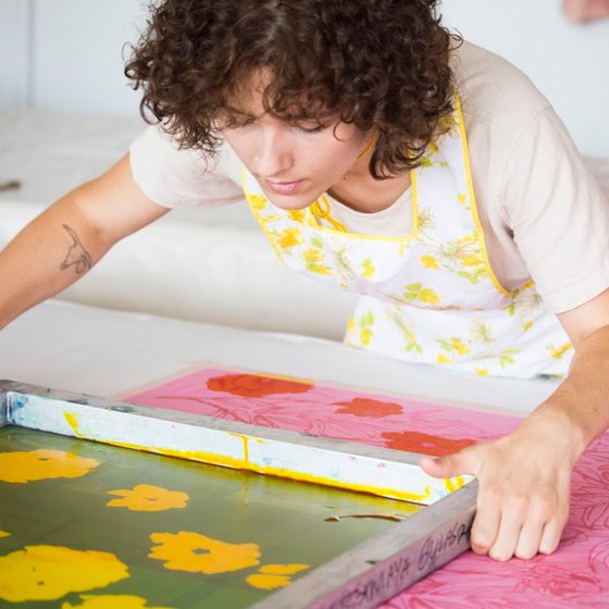 BFA Individualized Major student Maya works screenprinting fabrics in the dye lab