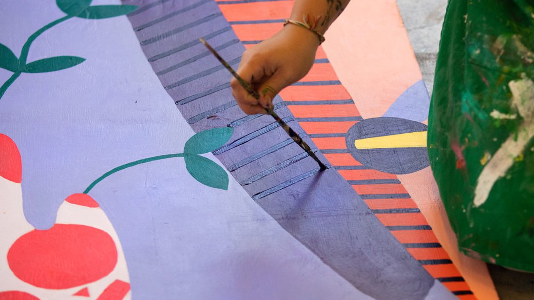 student working on mural for YBCA install
