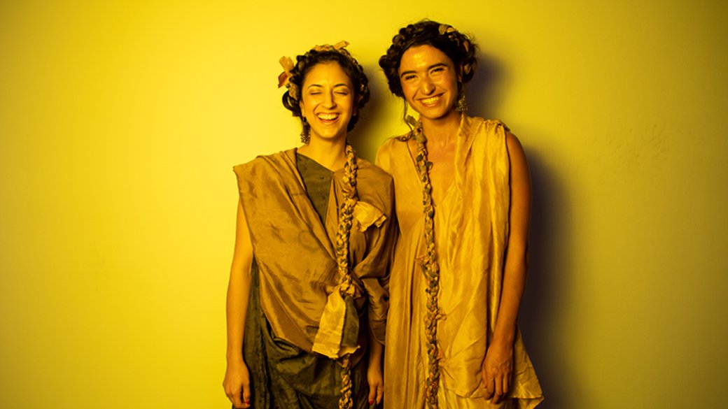 Portrait of two models at Fashion Experience 2019 bathed in yellow light