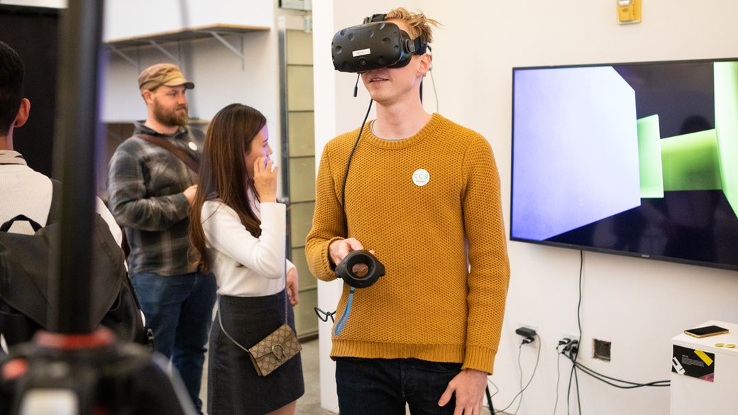 someone experiencing virtual reality at the graphic design final show