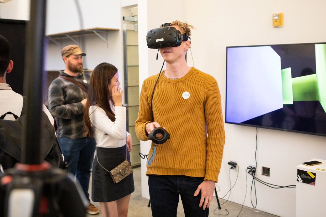 someone experiencing virtual reality at the graphic design final show