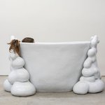 Nathan Lynch’s “The Same Larry” (2019, shown here with Kari Marboe), is a handmade ceramic soaking tub that fits two.