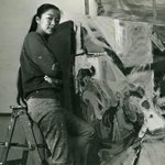 Artist Bernice Bing standing in front of her painting.