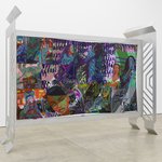 A mural-like installation of oil paintings and prints displaying Black female celebrities.