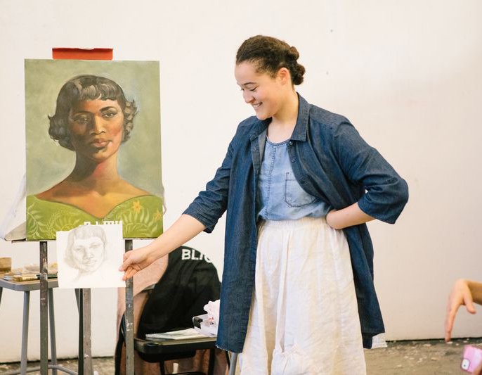 Painting and drawing student smiling during open crit_hero image_MB