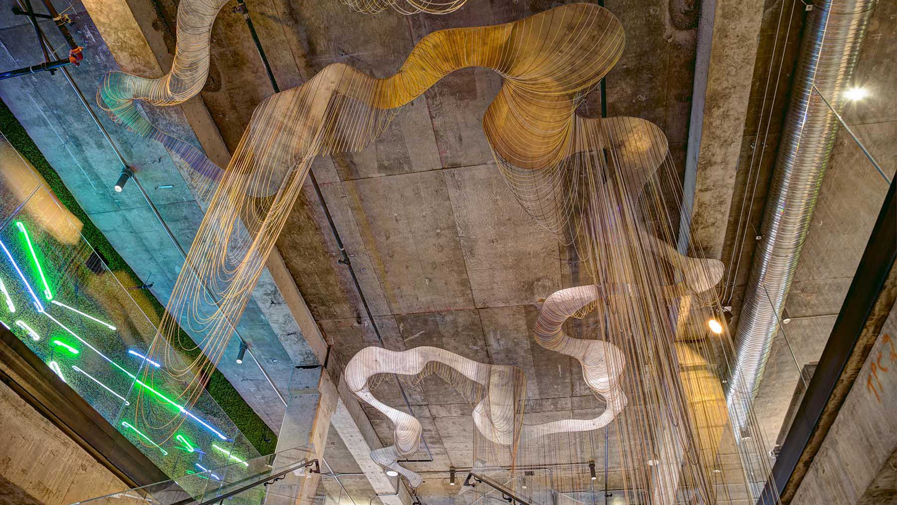 An immersive sculpture made of 11,000 feet of ball chain hanging from the ceiling.