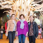 Portrait of the late Sandra Vivanco flanked by two students.