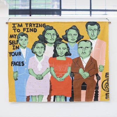 A painting of figures with text, “I’m trying to find myself in your faces.”