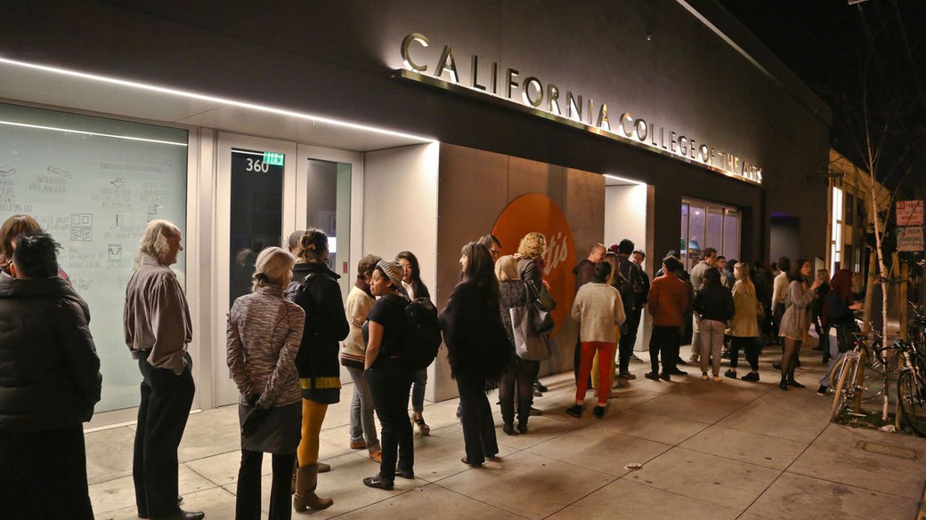 people lined up outside of Wattis