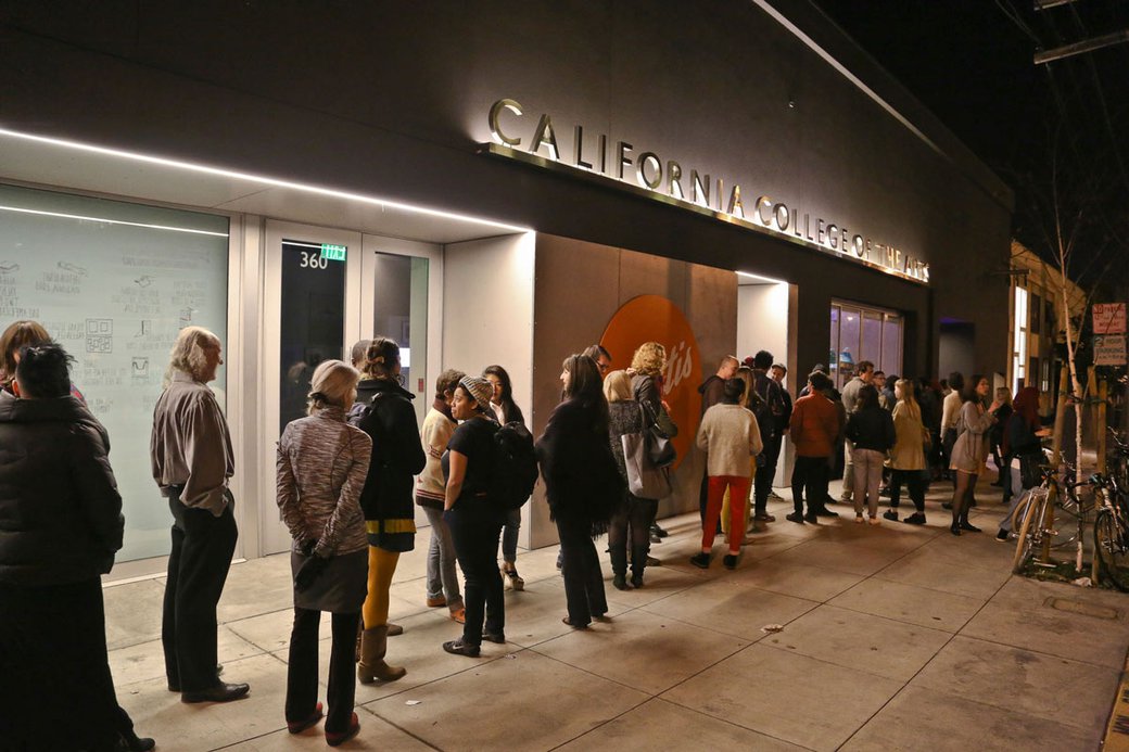 people lined up outside of Wattis