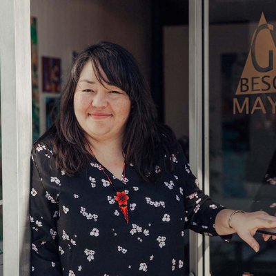 Alumna Yadira Cazares stading outside of her art gallery, Galería Beso Maya.