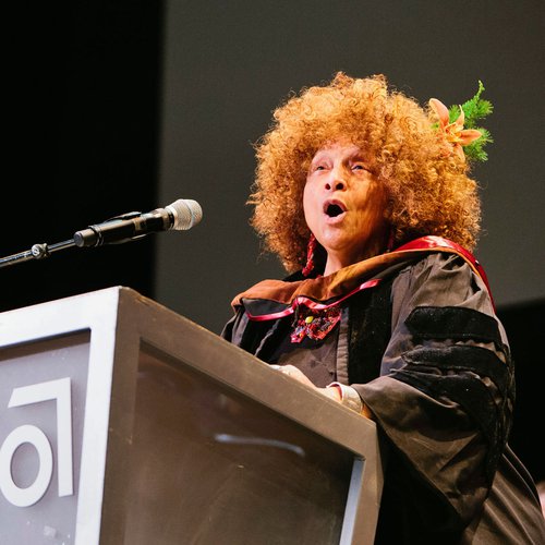 Joyce J. Scott singing at a podium.