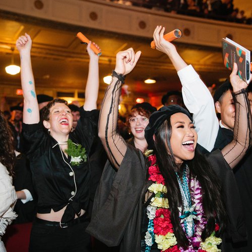 Students cheering for their friends during CCA's 2019 graduation ceremony.