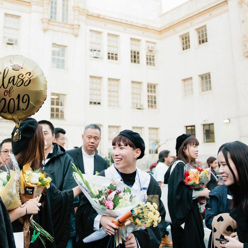 Students smiling after graduation.