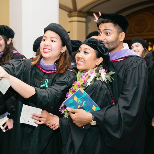 Students posing for a fun group selfie at their graduation ceremony.
