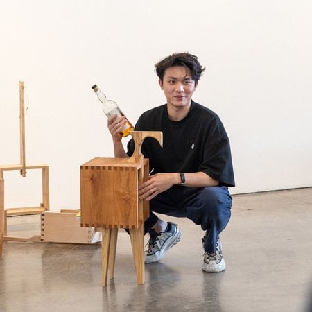 A transfer student showcases their furniture for a critique.