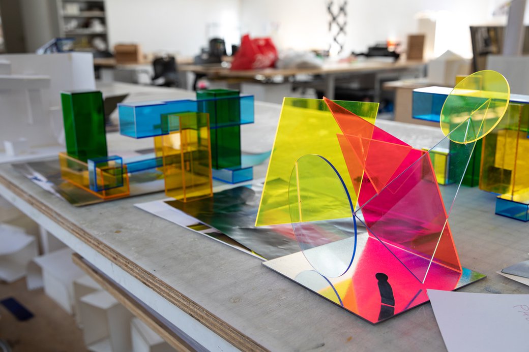Multicolored acrylic shapes laying on a desk.
