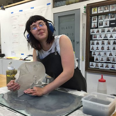 Student removing their sculpture in the glass Cold Shop