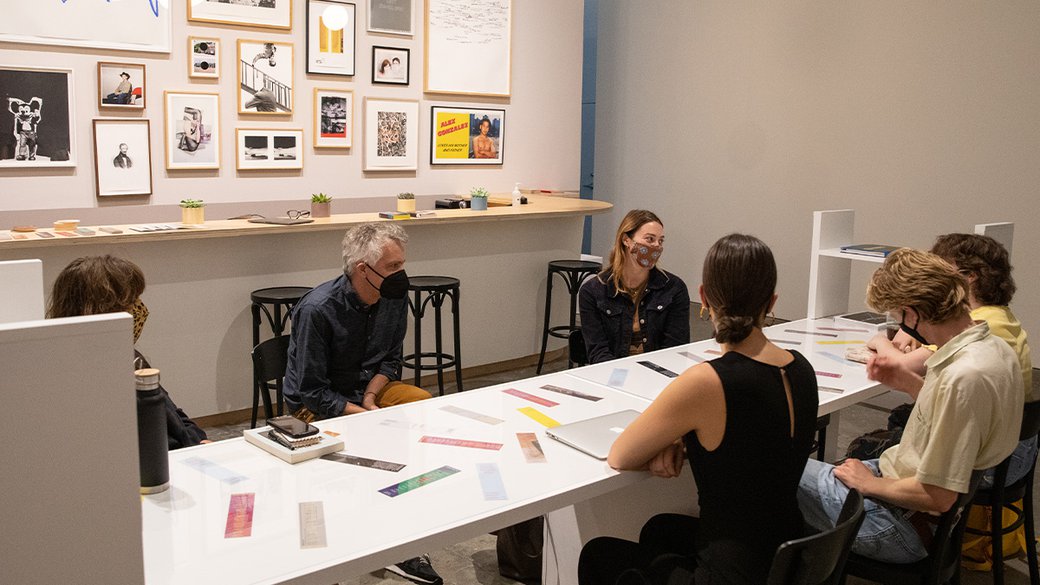 Anthony Huberman site with a group of people in the back bar at Wattis Institute for Contemporary Arts.