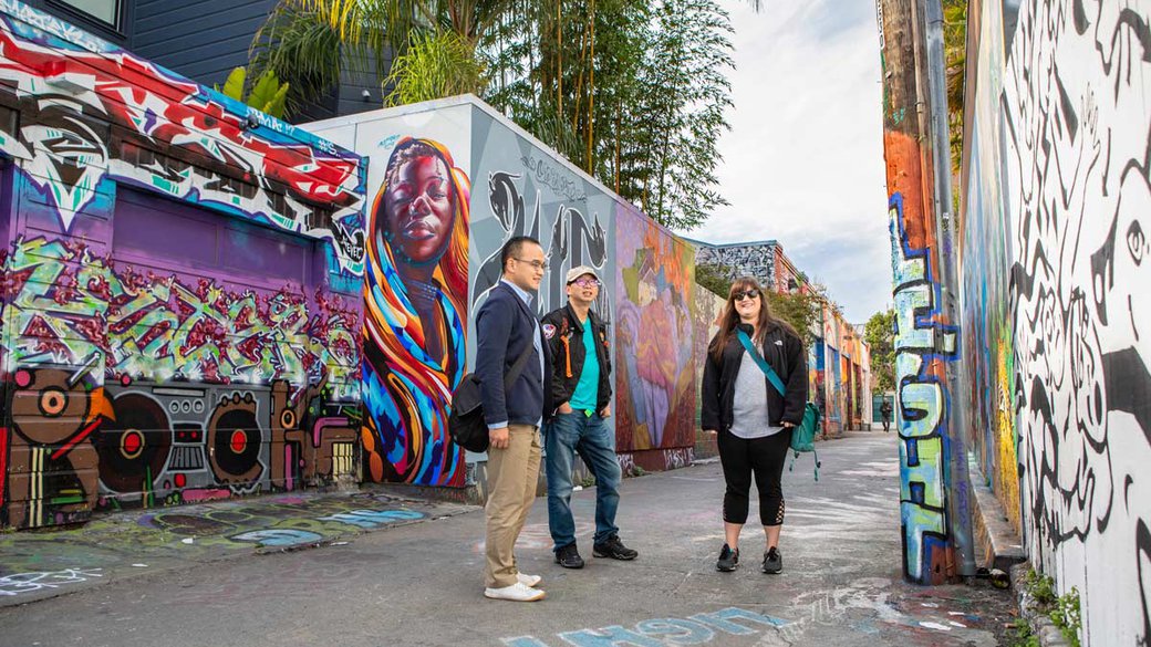 Students standing in Clarion Alley, Mission District's neighborhood for community and student murals