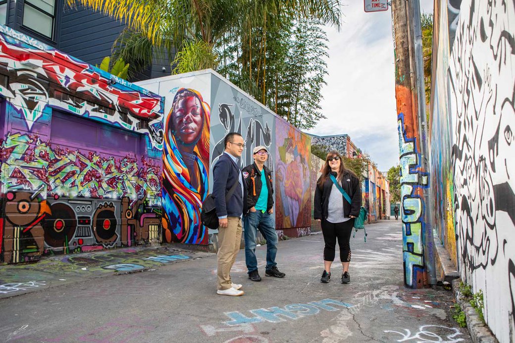 Students standing in Clarion Alley, Mission District's neighborhood for community and student murals