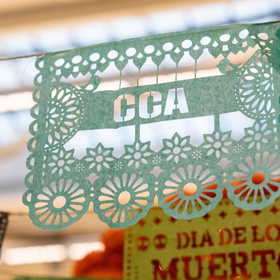 Tissue-paper art in the Mexican style with the letters CCA forming the design.