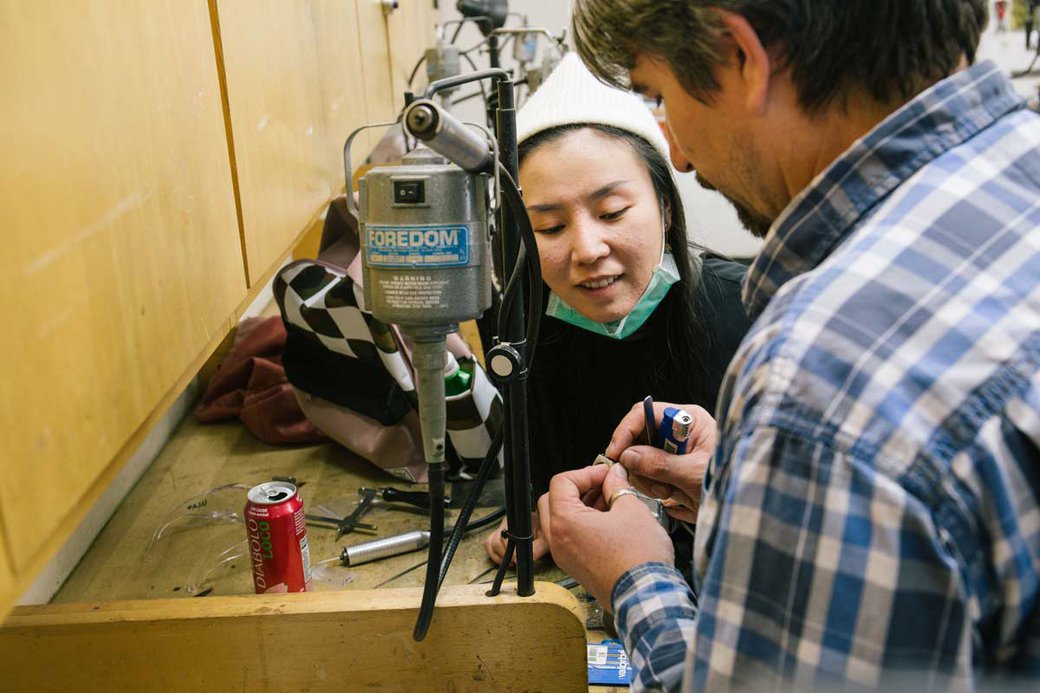 Metalworking student gets help from faculty.