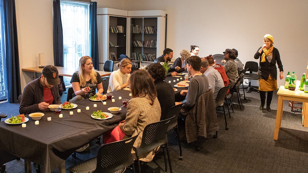 A group of students having dinner in the MFA Writing Studio.