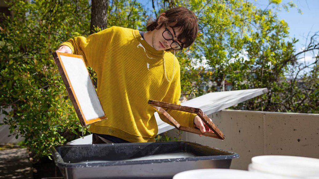 student making paper by hand