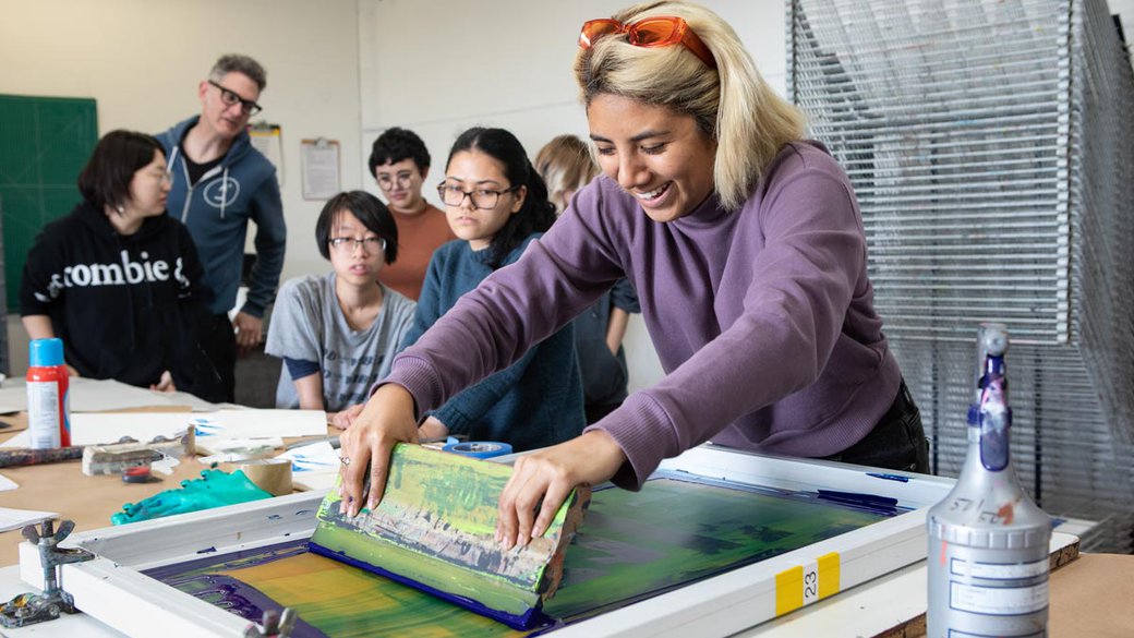 student learning how to screenprint