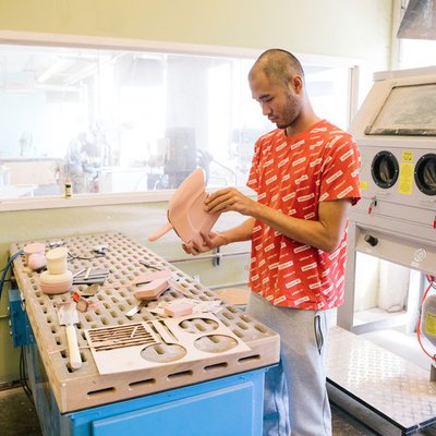 A student sands and refines their prototypes in the Model Shop.