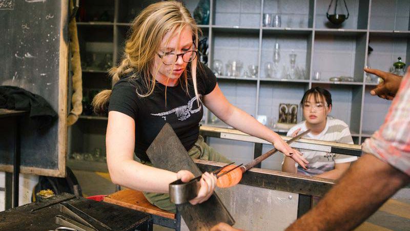 Students blowing glass in CCA's HOT SHOP