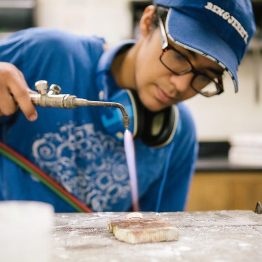 Jewelry and Metal Working student using a torch to mold their ring