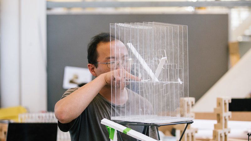 Architecture student working on their transparent model of a building_academics feature_MB