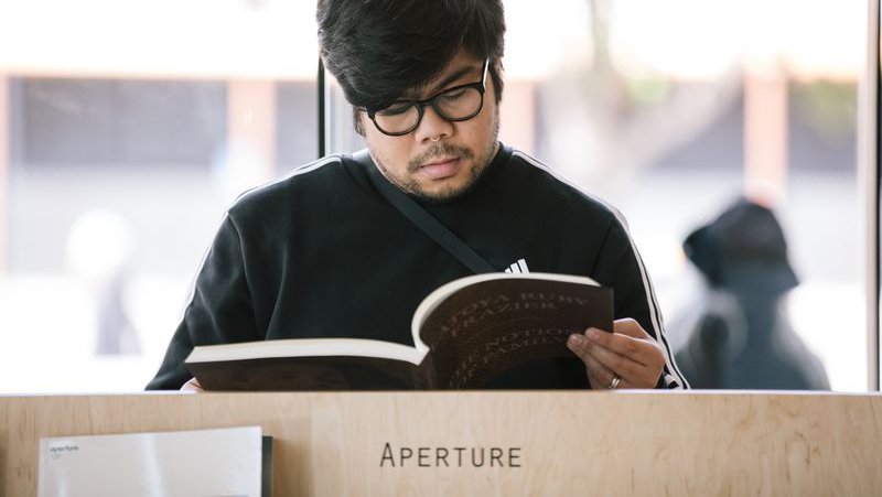Student accessing photography books at CCA's YBCA located Curatorial Research Bureau