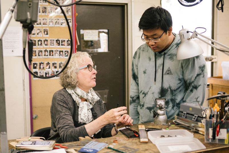Chair Marilyn da Silva helping Jewelry and Metal Working student
