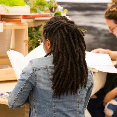 Student reading at the 2018 EOY Exhibition Writing Installation