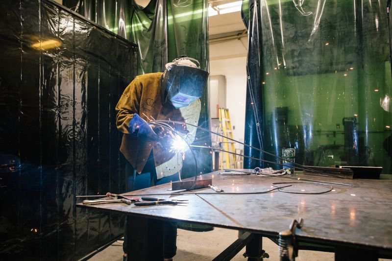 Student welding a sculpture during a metal working class.
