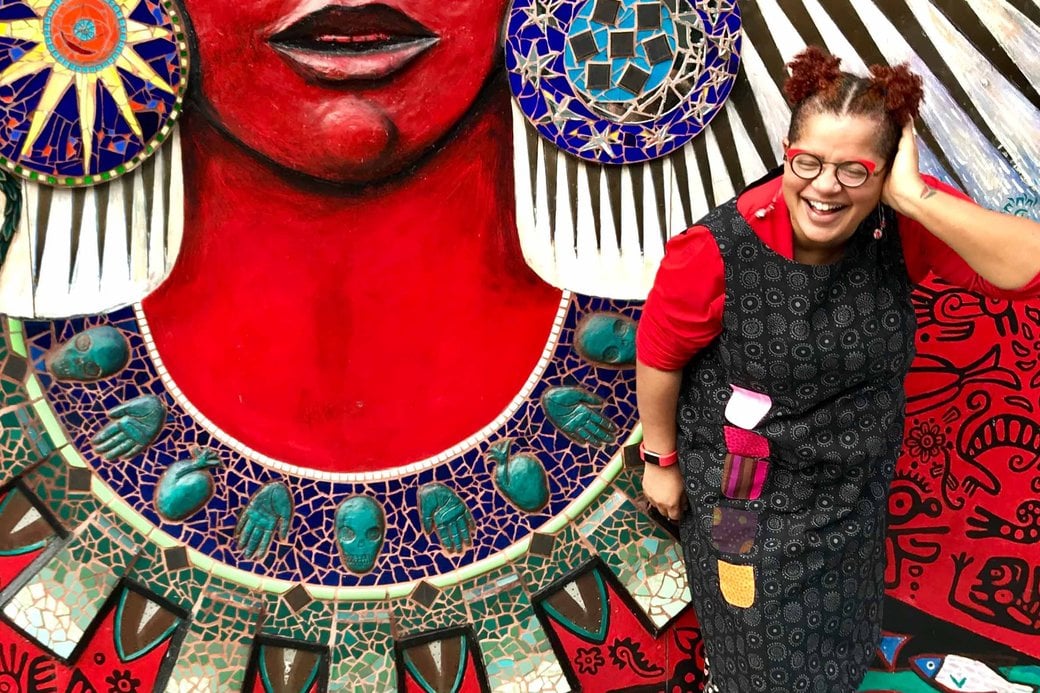 Portrait of Faith Adiele in front of a colorful mural.